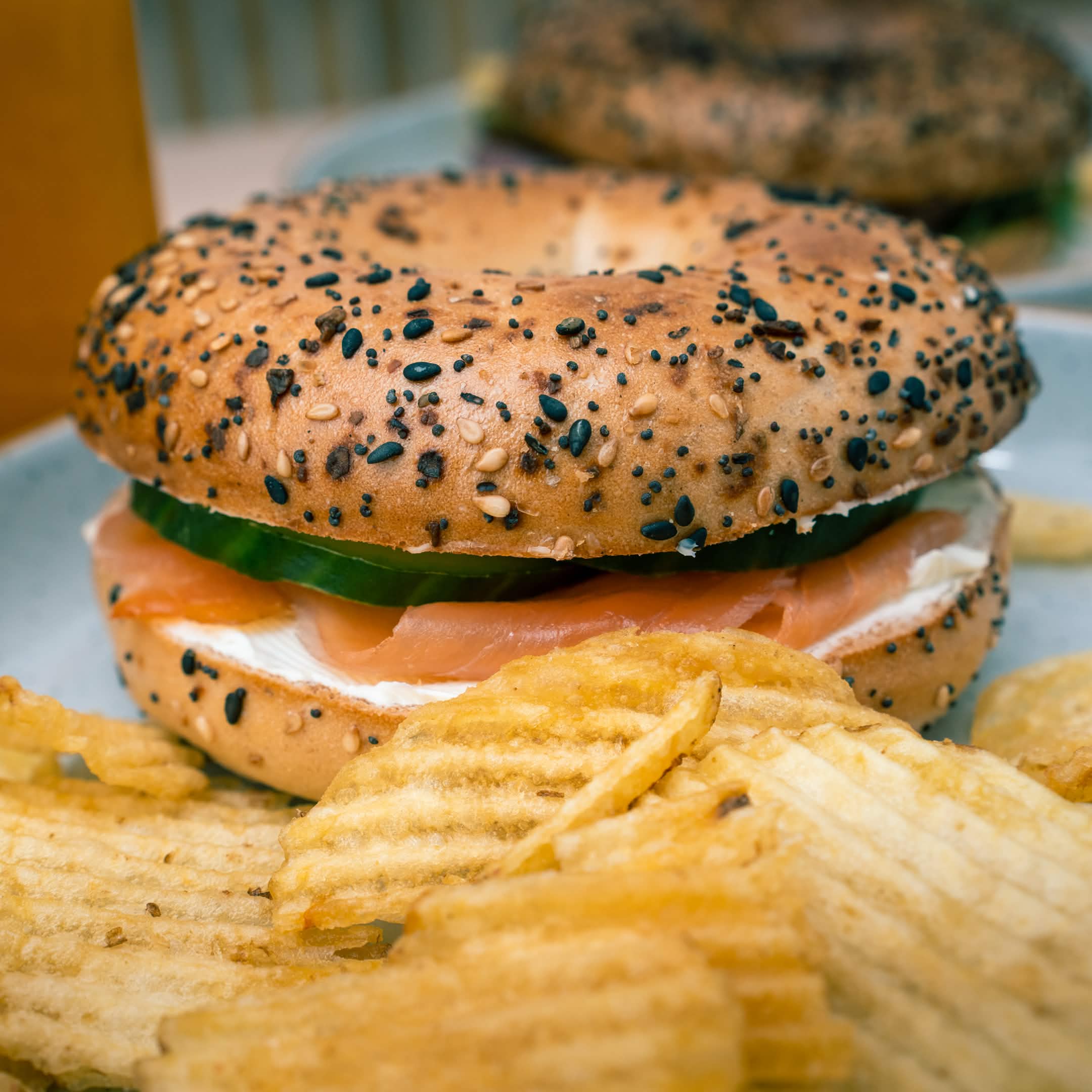 Everything bagel with cream cheese, smoked salmon and cucumber, served with crinkle-cut crisps at Cristina's Cafe Romford